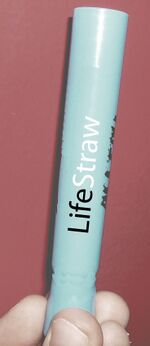Someone holding a LifeStraw