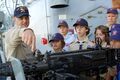 US Navy 061021-N-7498L-123 Senior Chief Cryptologic Technician (Collection) James Eaton explains to boy scouts from Troop 384 on the capabilities of the dual-mounted .50-caliber machine gun.jpg