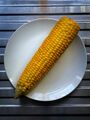 Boiled corn on a white plate.jpg